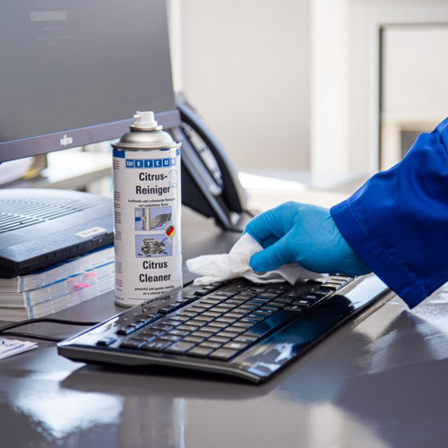 Citrus Cleaner disinfecting a keyboard